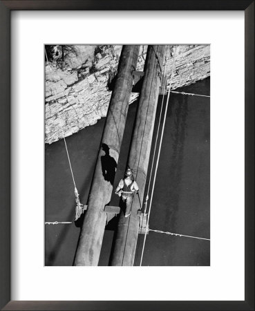 Worker Walking On The Texas Illinois Natural Gas Company's Pipeline Suspension Bridge by John Dominis Pricing Limited Edition Print image