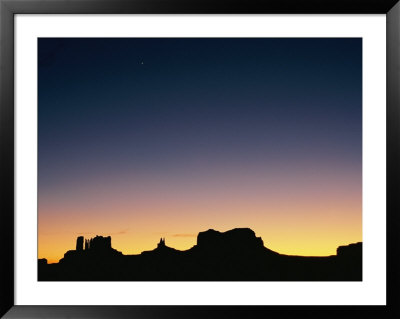 Sunset Silhouetting The Desert Landscape by Rich Reid Pricing Limited Edition Print image