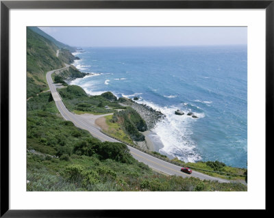 A Car Whizzes Down Hwy 1 Along Californias Big Sur Coastline by Rich Reid Pricing Limited Edition Print image