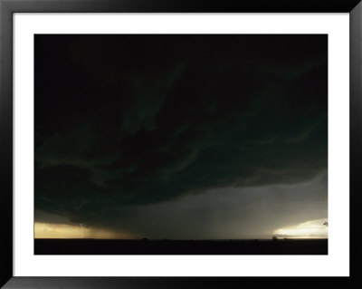 Lightning And Dark Clouds Over A Prairie Foretell A Possible Tornado by Peter Carsten Pricing Limited Edition Print image