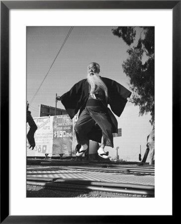 Elderly Japanese Movie Extra Jumping On Trampoline by Ralph Crane Pricing Limited Edition Print image