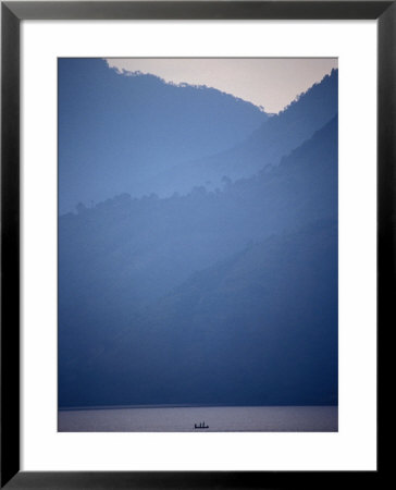 Boat On Misty Lago De Atitlan, Santiago Atitlan, Solola, Guatemala by Tony Wheeler Pricing Limited Edition Print image