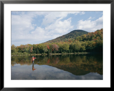 A Fisherman And His Reflection Are Surrounded By The Colors Of Fall by Richard Nowitz Pricing Limited Edition Print image