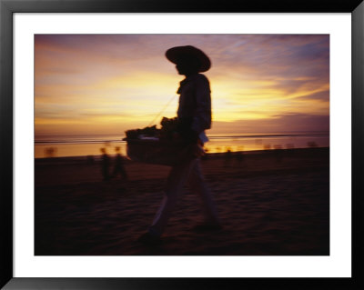 A Snack And Cigarette Vendor In A Straw Hat On The Beach At Dusk by Eightfish Pricing Limited Edition Print image