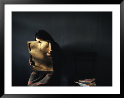 A Grieving Woman Holds A Photograph Of Her Murdered Son by James L. Stanfield Pricing Limited Edition Print image