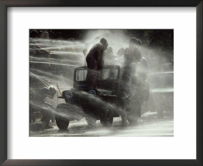 Jeep Full Of Innocent Onlookers Is Sprayed With Water During The Water Festival by James L. Stanfield Pricing Limited Edition Print image