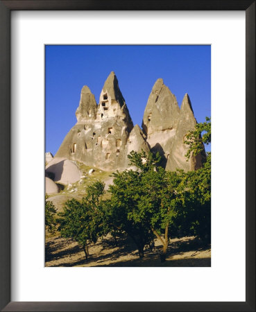 Pigeon Cotes Cut In Volcanic Rock, Apricot Trees In Foreground, Uchisar, Cappadocia, Turkey by Christopher Rennie Pricing Limited Edition Print image
