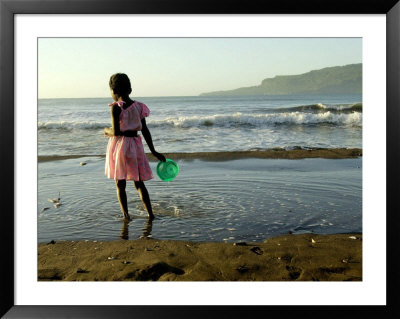 A Girl Walks On The Beach In Jacmel, Haiti, In This February 5, 2001 by Lynne Sladky Pricing Limited Edition Print image