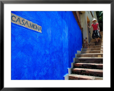 Young Women Decending Stairs Outside Blue Painted Casa Mona In Zona Centro, Puerto Vallarta, Mexico by Anthony Plummer Pricing Limited Edition Print image