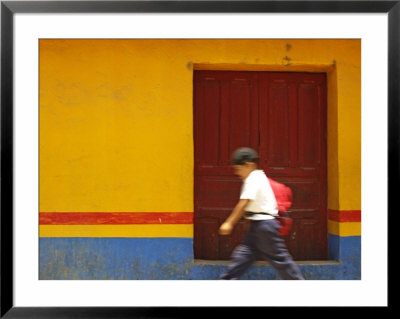 Schoolboy Running Past Wooden Door And Colorful Wall, Guatemala by Dennis Kirkland Pricing Limited Edition Print image