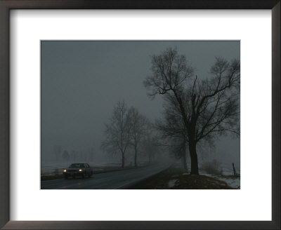 A Foggy Winter View Of A Car Driving Down Highway 11 by George F. Mobley Pricing Limited Edition Print image