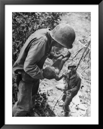 American Lieutenant Carrying Micronesian Baby He Found In Cave Japanese Soldiers Holed Up There by W. Eugene Smith Pricing Limited Edition Print image