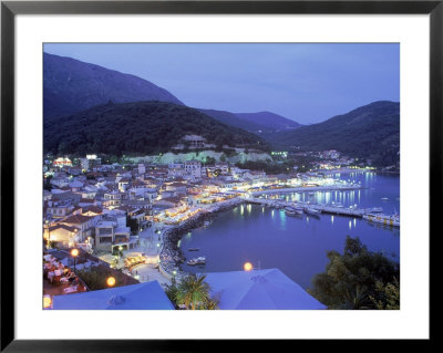 Town & Harbor At Night, Epirus, Greece by Walter Bibikow Pricing Limited Edition Print image