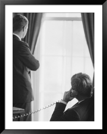 Pres. John F. Kennedy On Telephone While Brother, Attorney General Robert F. Kennedy Stands Nearby by Art Rickerby Pricing Limited Edition Print image