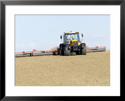 Tractor Rolling A Recently Ploughed Field Near Moreton-In-Marsh, England by Martin Page Pricing Limited Edition Print image
