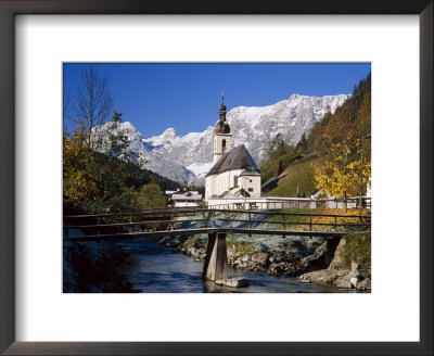 Wooden Bridge In Front Of The Church At Ramsau In The Mountains Of Bavaria, Germany by Gavin Hellier Pricing Limited Edition Print image