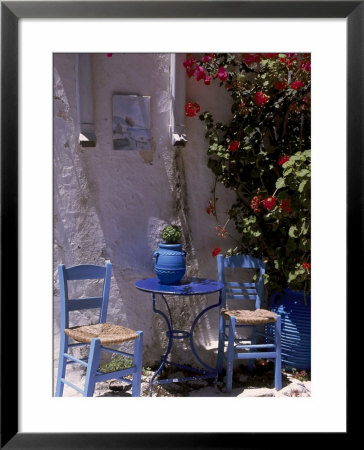 Chairs And Table Outside Of Building, Greece by Rick Strange Pricing Limited Edition Print image