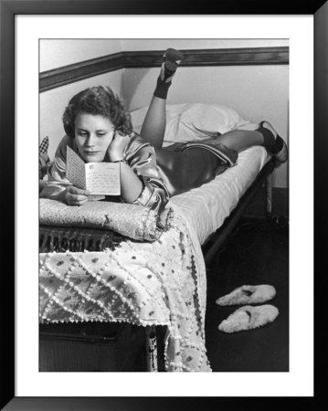 Vassar Student Lounging On Bed Reading Letter by Alfred Eisenstaedt Pricing Limited Edition Print image