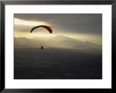 A Botanist Flies Over A Field In A Powered Paraglider by Jim Webb Pricing Limited Edition Print image