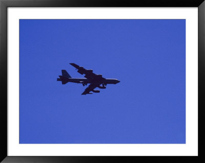 A Military Jet Speeds Through A Clear Blue Sky by Raul Touzon Pricing Limited Edition Print image
