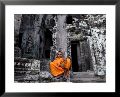 A Buddhist Monk Relaxes In The Bayon Temple, Angkor, Unesco World Heritage Site, Cambodia by Andrew Mcconnell Pricing Limited Edition Print image