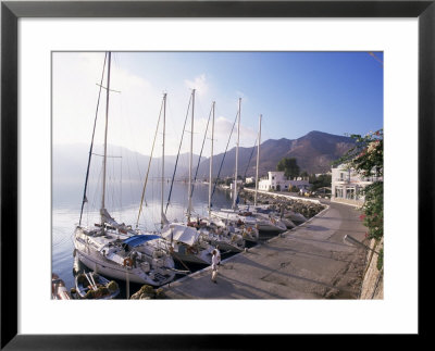 Yachts, Livadhia, Island Of Tilos, Dodecanese, Greece by Ken Gillham Pricing Limited Edition Print image