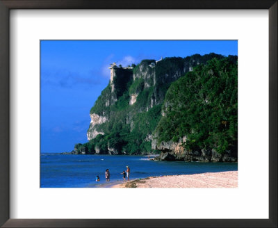 People In Water At Tumon Beach With Amantes (Two Lovers) Point Behind, Tumon, Guam by John Elk Iii Pricing Limited Edition Print image