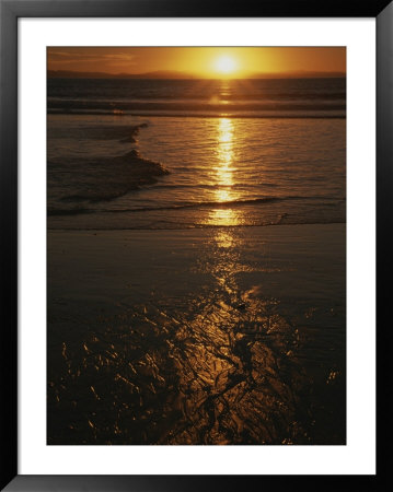 A Yellow Sunset Reflected Upon The Water At Manhattan Beach by Stacy Gold Pricing Limited Edition Print image