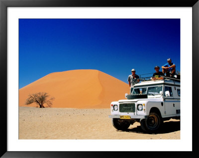 Men On Four Wheel Drive Vehicle At Dune 45 In Namib Nauklaft National Park, Sossusvlei, Namibia by Christer Fredriksson Pricing Limited Edition Print image