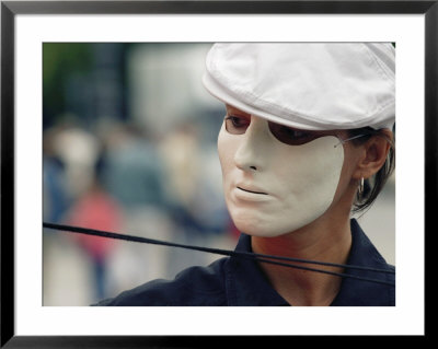 A Street Performer Wears A Mask Concealing Her Expression by Jim Webb Pricing Limited Edition Print image