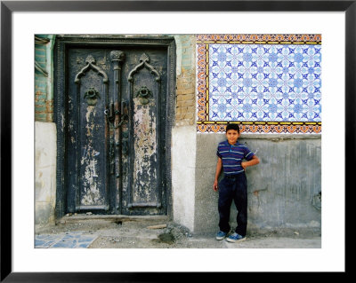 Boy Standing Near Door Of Historic House, Baghdad, Iraq by Jane Sweeney Pricing Limited Edition Print image