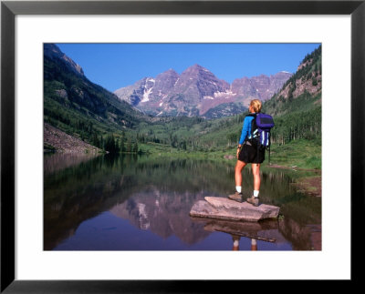 Hiker Stands On A Rockoverlooking Maroon Bells, Aspen, Colorado, Usa by Cheyenne Rouse Pricing Limited Edition Print image