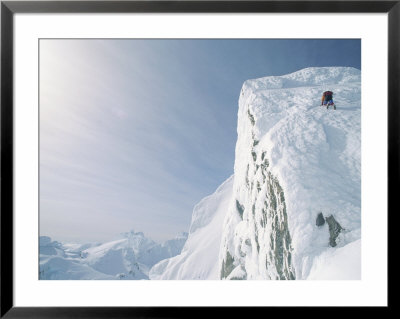 A Mountain Climber Scrambles Up A Steep, Rime-Covered Slope by Gordon Wiltsie Pricing Limited Edition Print image