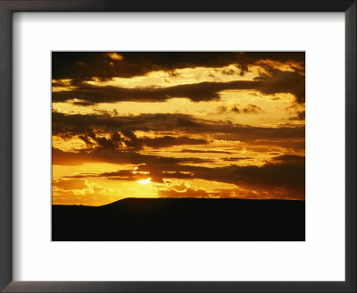 Clouds Are Colored Shades Of Orange By The Low Sun Over 70 Mile Butte by Raymond Gehman Pricing Limited Edition Print image