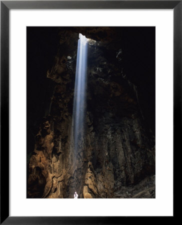Beam Of Sunlight Falling On A Person Standing In A Cave by Peter Carsten Pricing Limited Edition Print image