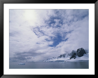 A Cloud-Filled Sky Over Mountains On The Antarctic Peninsula by Gordon Wiltsie Pricing Limited Edition Print image