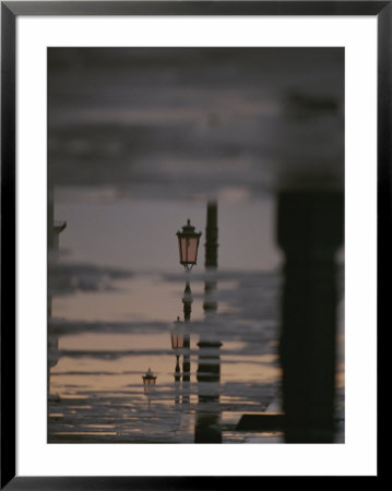 Lampposts Reflected On Wet Pavement After A Rain by Raul Touzon Pricing Limited Edition Print image