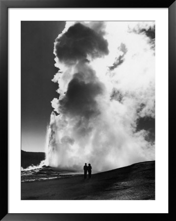 Couple Looking At Geyser Old Faithful At Yellowstone National Park by Alfred Eisenstaedt Pricing Limited Edition Print image