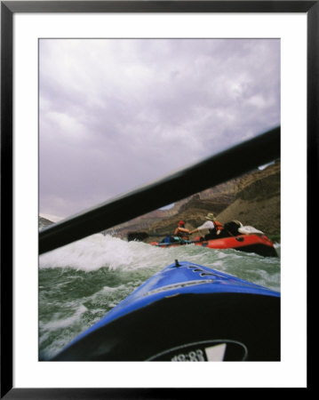 Bow Of A Kayak And A Raft Among Waves Viewed From Under A Paddle by Mark Cosslett Pricing Limited Edition Print image
