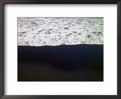 Frothy Pacific Ocean Water Pours Onto A Black Sandy Beach by Raul Touzon Pricing Limited Edition Print image