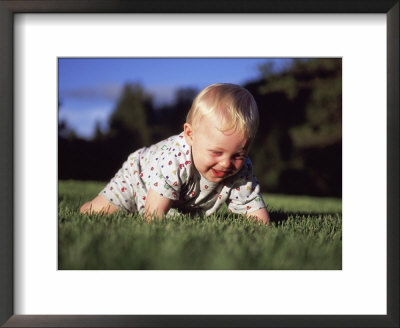 A Baby Boy Crawls Through The Green Grass by Joel Sartore Pricing Limited Edition Print image