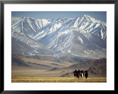 Four Eagle Hunters In Tolbo Sum, Golden Eagle Festival, Mongolia by Amos Nachoum Pricing Limited Edition Print image