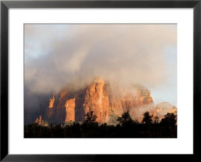 Sunlight Burning Off Morning Fog Surrounding The Red Rocks Of Sedona by Charles Kogod Pricing Limited Edition Print image