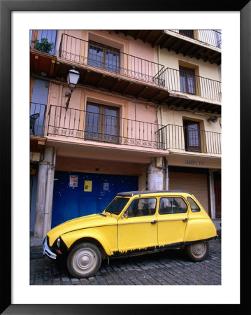 Yellow Citroen Parked Outside Apartments, Calatayud, Spain by John Banagan Pricing Limited Edition Print image