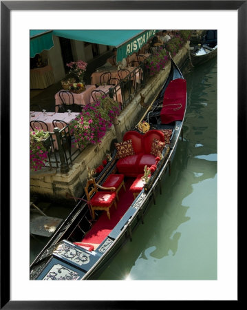 Fancy Gondola Parked In A Canal Next To A Restaurant, Venice, Italy by Todd Gipstein Pricing Limited Edition Print image