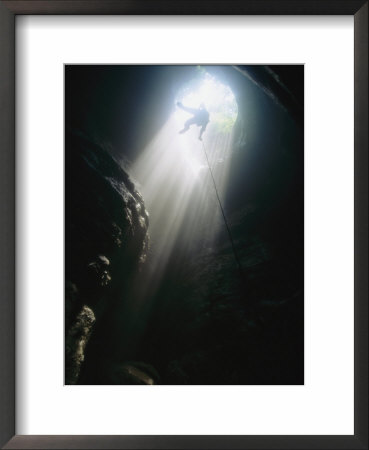 A Spelunker Rappels The Entrance Drop Of Stephens Gap, A 150-Foot Deep Pit In Alabama by Stephen Alvarez Pricing Limited Edition Print image