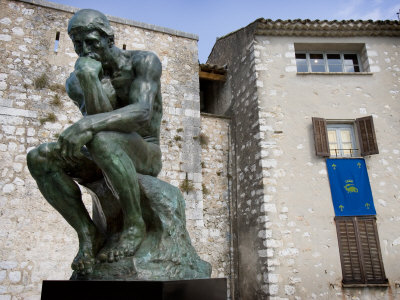 Bronze Monument Le Penseur 1880 With Old Buildings, Saint-Paul De France, Cote D'azure, France by Robert Eighmie Pricing Limited Edition Print image