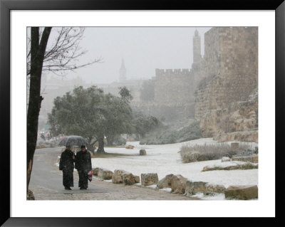 Two Priests Walk In Snow In Front Of The Jaffa Gate In Jerusalem's Old City, December 27, 2006 by Oded Balilty Pricing Limited Edition Print image