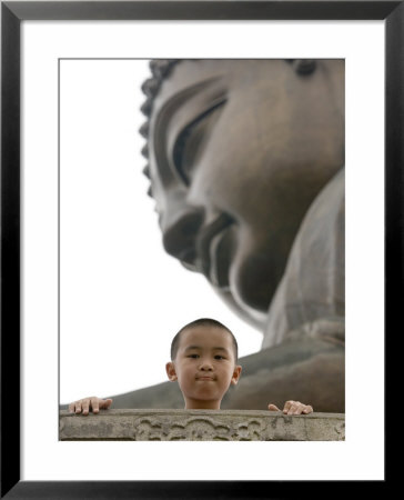 Young Boy In Front Of Giant Buddha At Ngong Ping Plateau, China by Holger Leue Pricing Limited Edition Print image