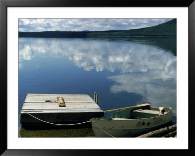 Rowboat Moored At Edge Of Lake Showing Reflections Of Clouds In Its Still Waters, In New England by Dmitri Kessel Pricing Limited Edition Print image